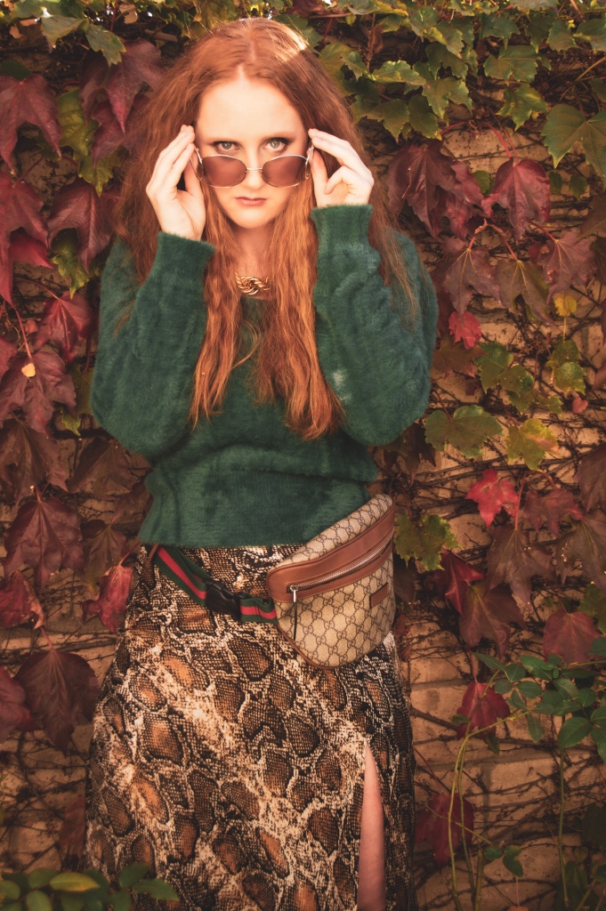 Portrait of a redhead in surrounded by fall leaves